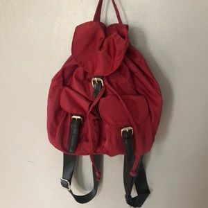 Maroon backpack purse with black straps.